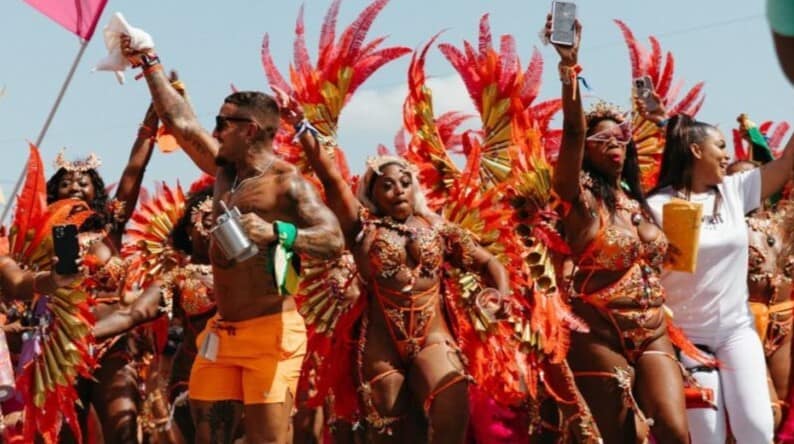 P. Orianwo Bespoke Twin Island LUXE Trinidad Carnival 2027 Purple Star Travel Guru Gang crossing the stage with Spirit Mas, Trinidad Carnival.
